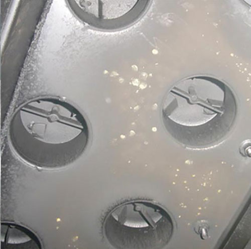 Chemical decontamination cleans bubble cap trays successfully